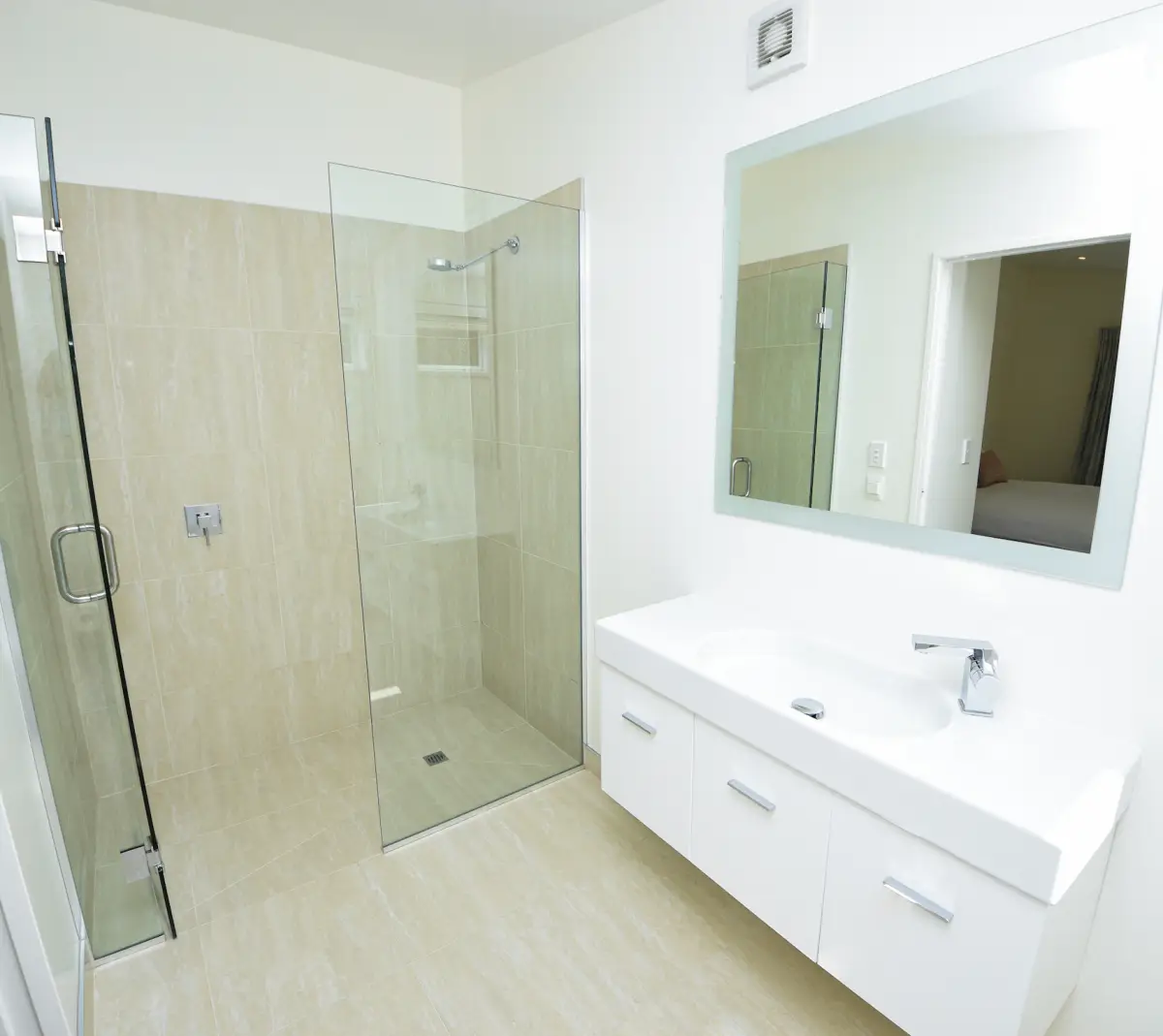 Outhouse Bathroom with Walk-In Glass Shower and Vanity 