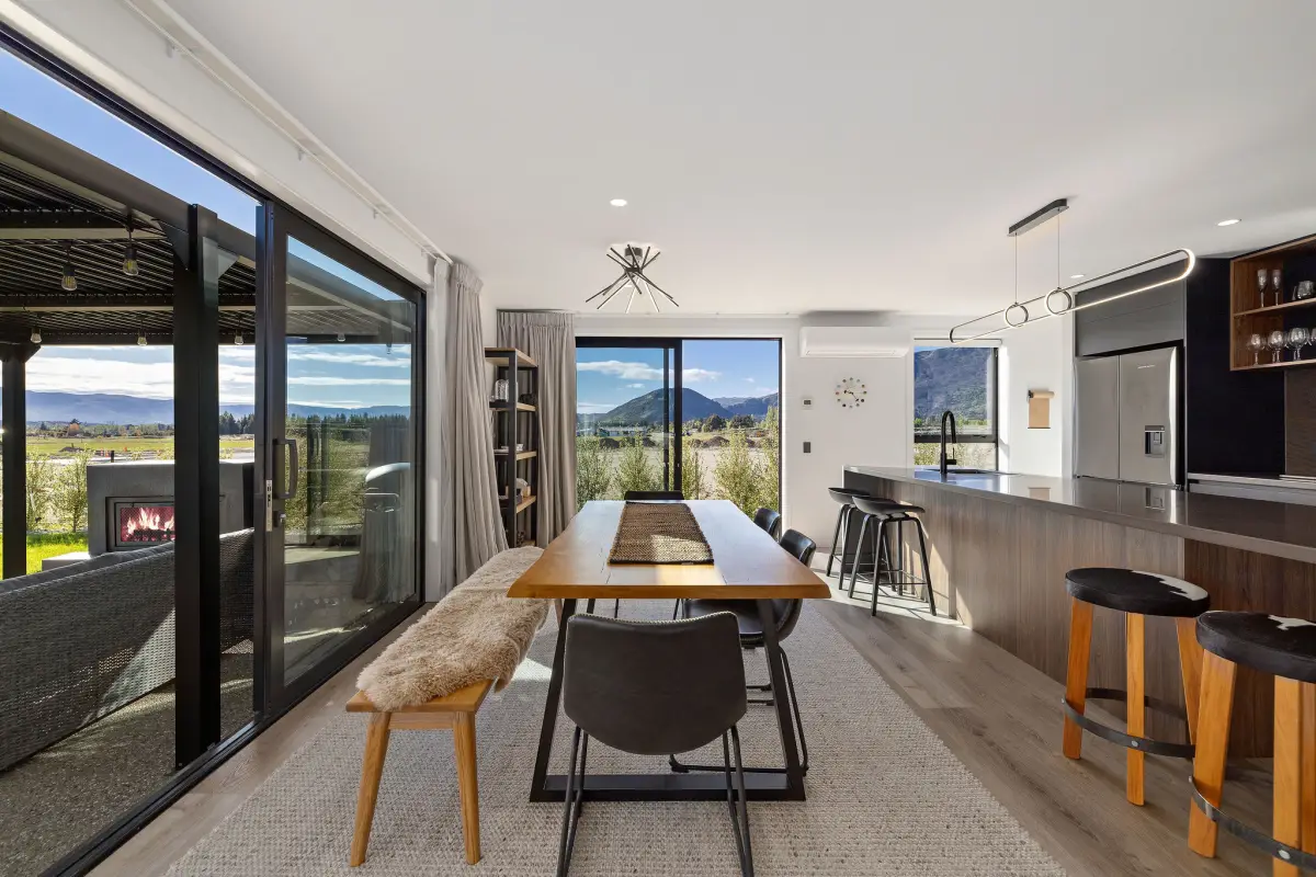 Dining leading onto a patio with outdoor fireplace