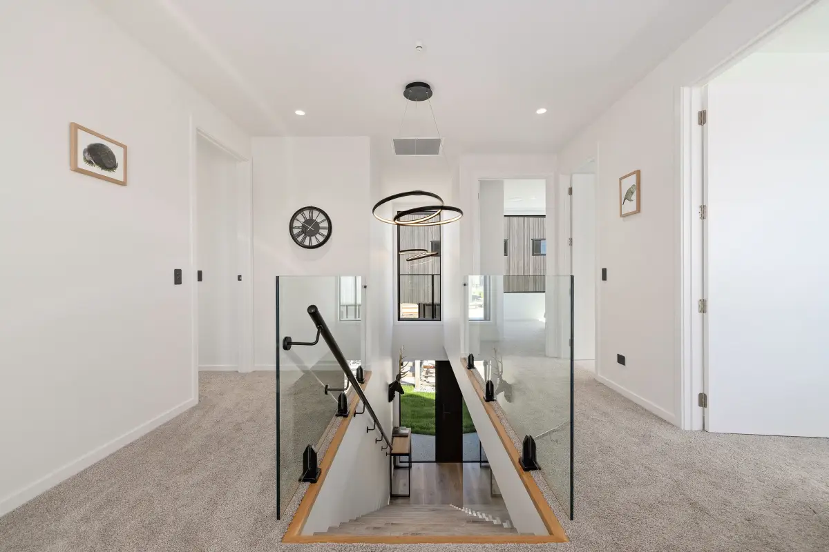 Staircase leading to the upper level with 3 bedrooms